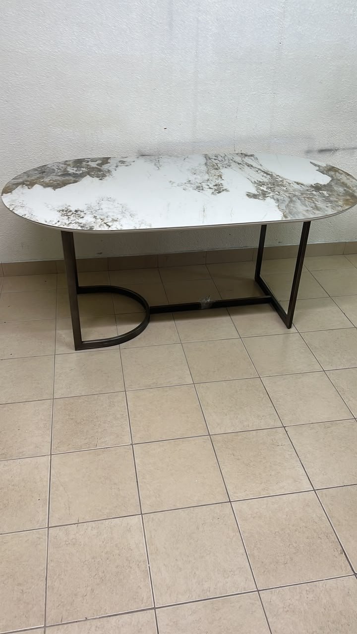 An oval dining table with a marble-patterned ceramic top, surrounded by four chairs upholstered in light beige fabric and featuring button-tufted backrests. - Image 7