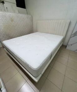 An upholstered double bed in white or light beige with a striped headboard, featuring a comfortable white mattress – Home Centre. - Image 2