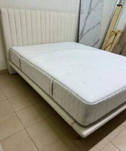 An upholstered double bed in white or light beige with a striped headboard, featuring a comfortable white mattress – Home Centre. - Image 4