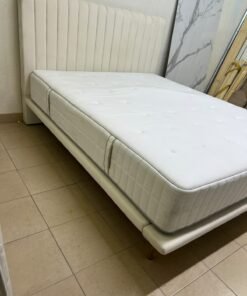 An upholstered double bed in white or light beige with a striped headboard, featuring a comfortable white mattress – Home Centre. - Image 5