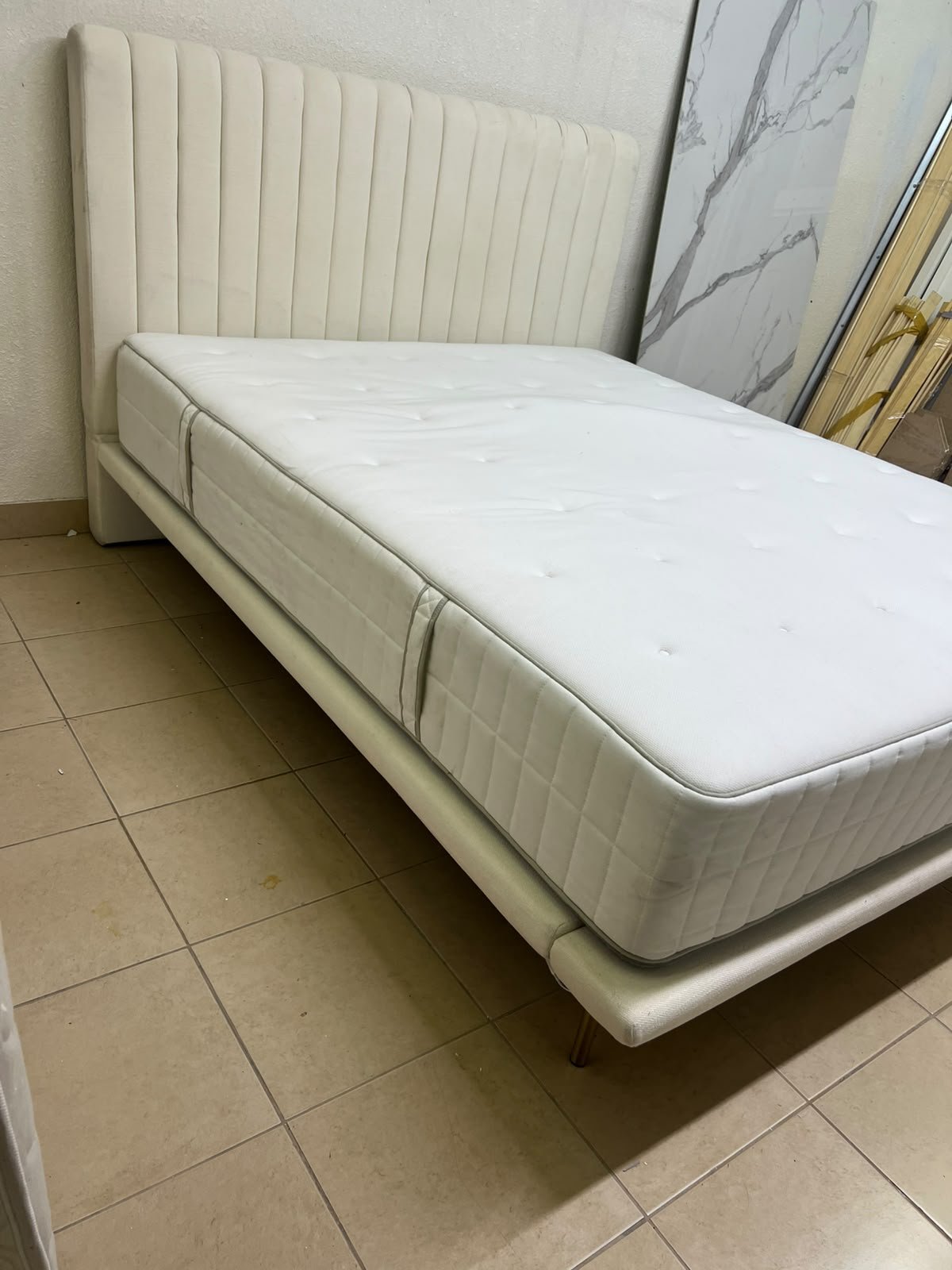 An upholstered double bed in white or light beige with a striped headboard, featuring a comfortable white mattress – Home Centre. - Image 5