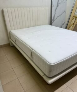 An upholstered double bed in white or light beige with a striped headboard, featuring a comfortable white mattress – Home Centre. - Image 6