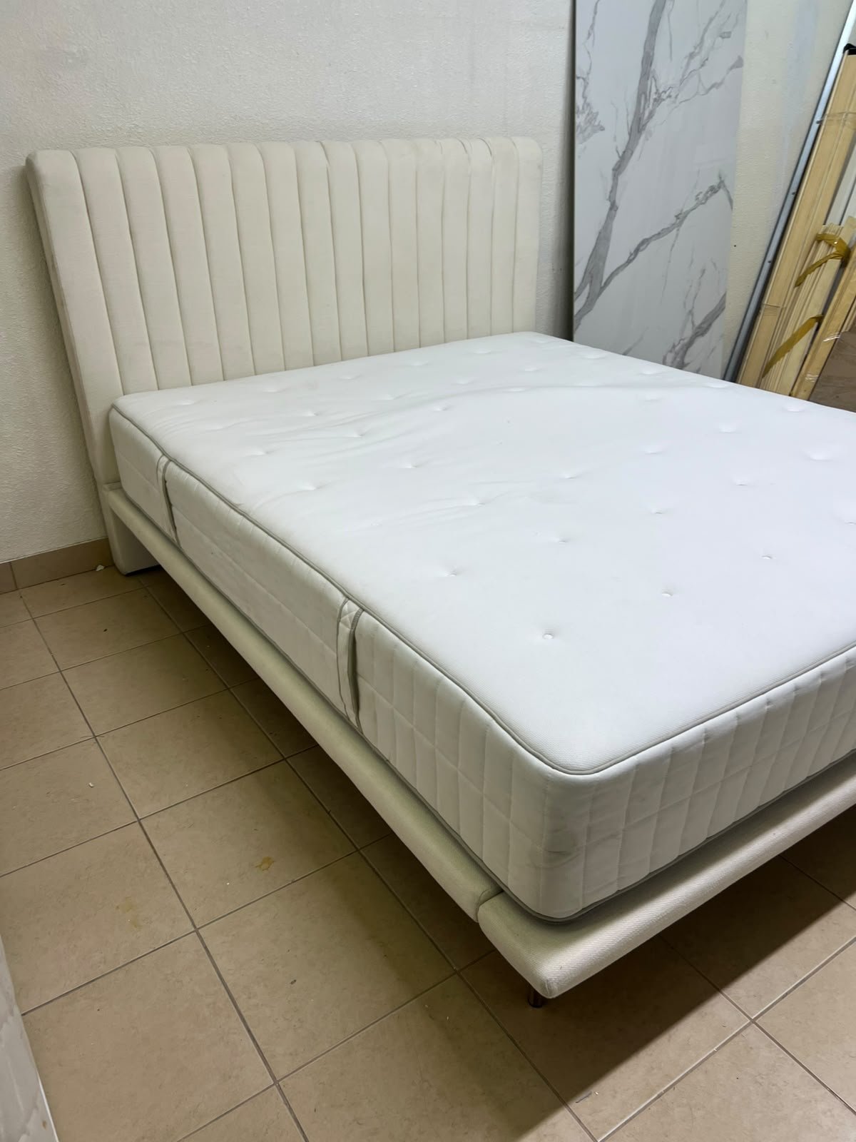 An upholstered double bed in white or light beige with a striped headboard, featuring a comfortable white mattress – Home Centre. - Image 6