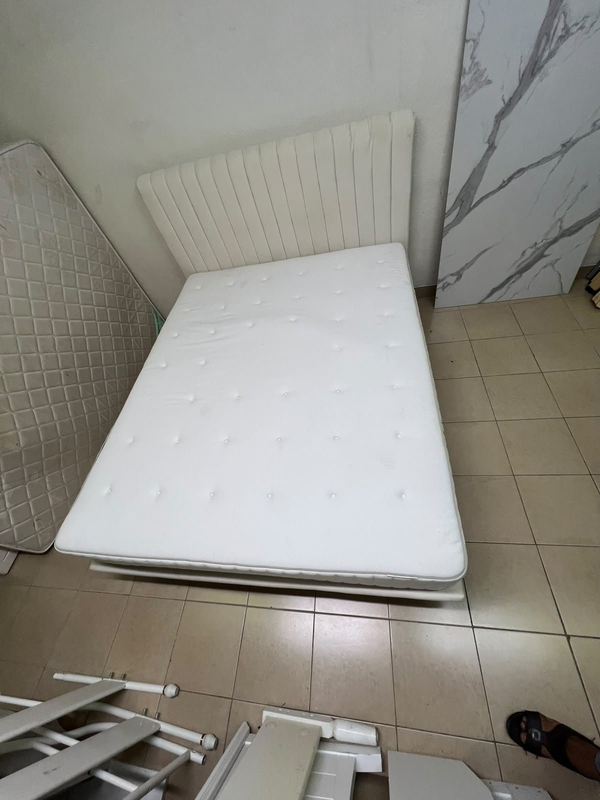 An upholstered double bed in white or light beige with a striped headboard, featuring a comfortable white mattress – Home Centre. - Image 8