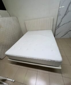 An upholstered double bed in white or light beige with a striped headboard, featuring a comfortable white mattress – Home Centre. - Image 12