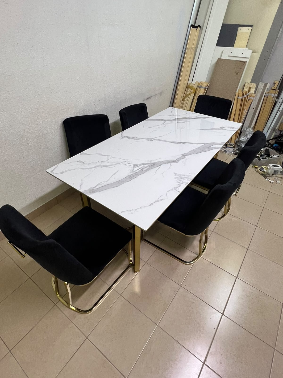 A modern six-seater dining set featuring an elegant design that combines a white marble-patterned tabletop with a gold metal base and frame, paired with black velvet chairs featuring matching gold legs. - Image 2