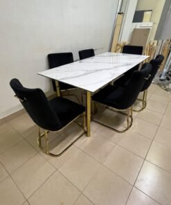 A modern six-seater dining set featuring an elegant design that combines a white marble-patterned tabletop with a gold metal base and frame, paired with black velvet chairs featuring matching gold legs. - Image 5