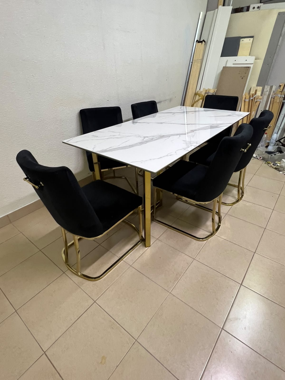 A modern six-seater dining set featuring an elegant design that combines a white marble-patterned tabletop with a gold metal base and frame, paired with black velvet chairs featuring matching gold legs. - Image 5