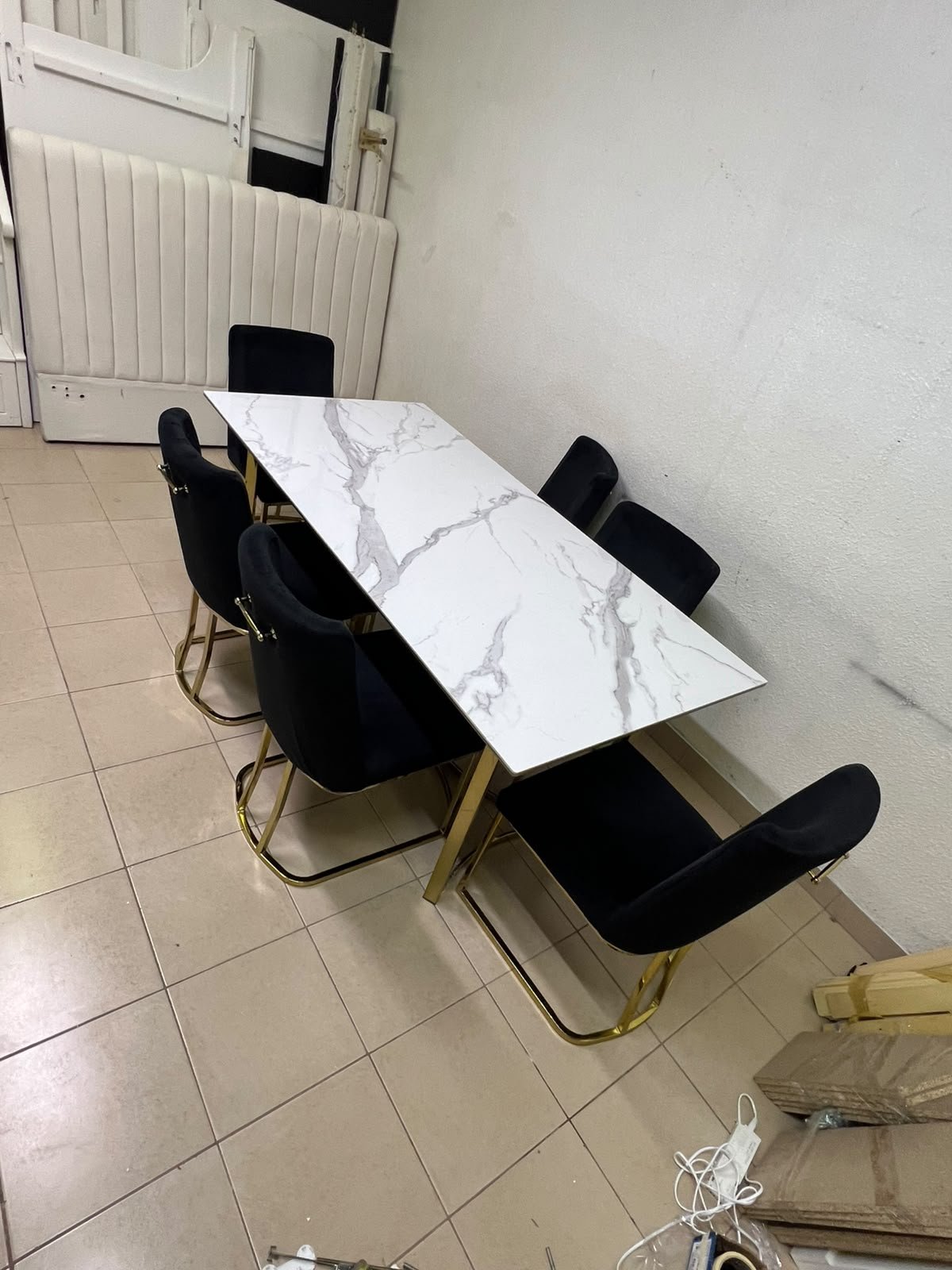 A modern six-seater dining set featuring an elegant design that combines a white marble-patterned tabletop with a gold metal base and frame, paired with black velvet chairs featuring matching gold legs. - Image 6