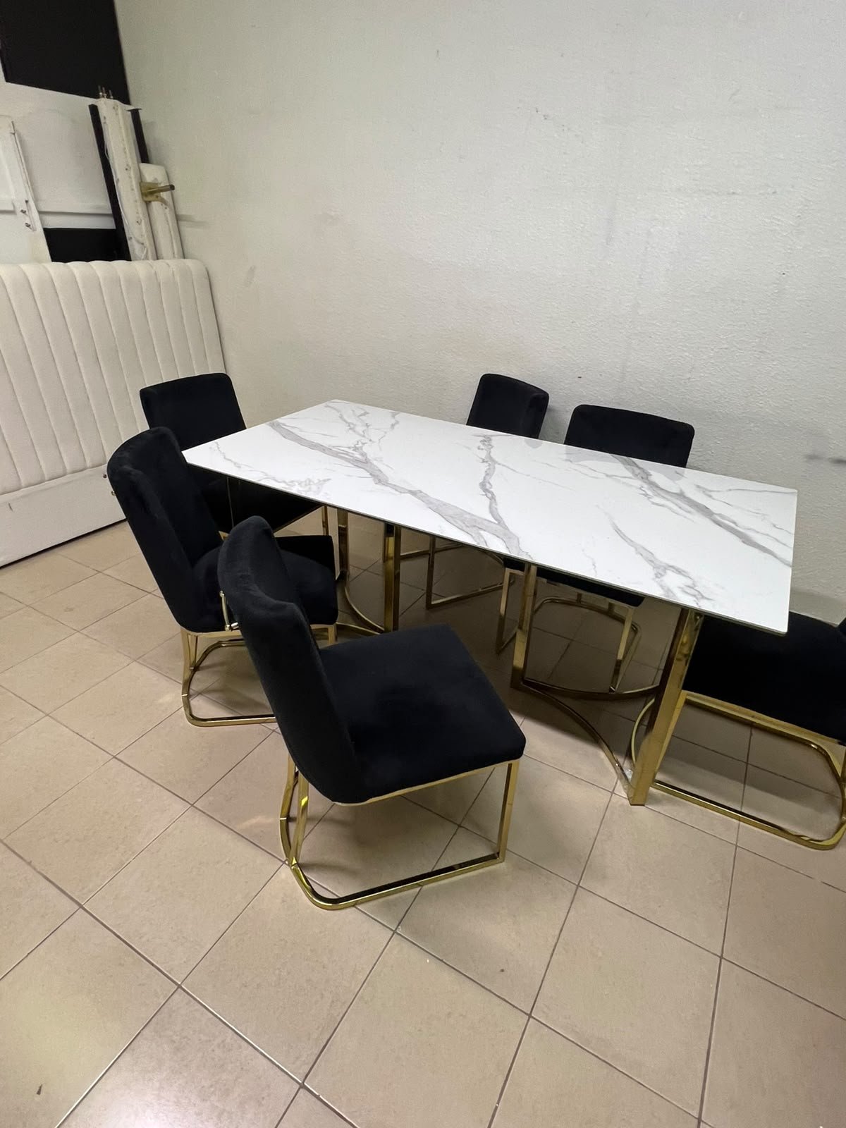 A modern six-seater dining set featuring an elegant design that combines a white marble-patterned tabletop with a gold metal base and frame, paired with black velvet chairs featuring matching gold legs. - Image 7