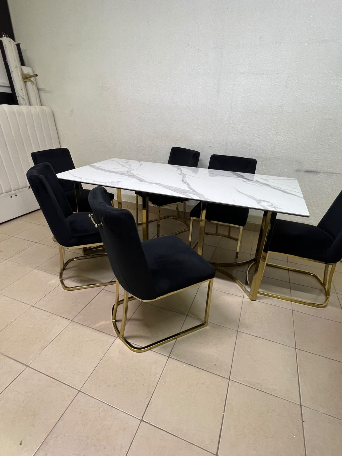A modern six-seater dining set featuring an elegant design that combines a white marble-patterned tabletop with a gold metal base and frame, paired with black velvet chairs featuring matching gold legs. - Image 10