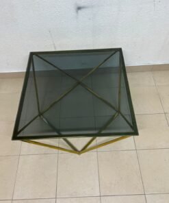 A modern, square coffee table featuring a dark or smoked glass top and a cohesive, diamond-inspired geometric base made of metal or polished gold-tone steel. - Image 5