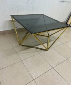 A modern, square coffee table featuring a dark or smoked glass top and a cohesive, diamond-inspired geometric base made of metal or polished gold-tone steel. - Image 8