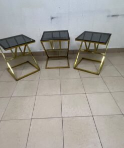 "Zicon" side table set featuring a contemporary geometric Z-shaped design, with gold-finished stainless steel or metal bases and dark or reflective glass tops. - Image 3
