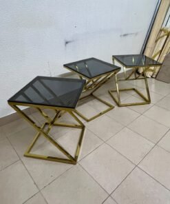 "Zicon" side table set featuring a contemporary geometric Z-shaped design, with gold-finished stainless steel or metal bases and dark or reflective glass tops.