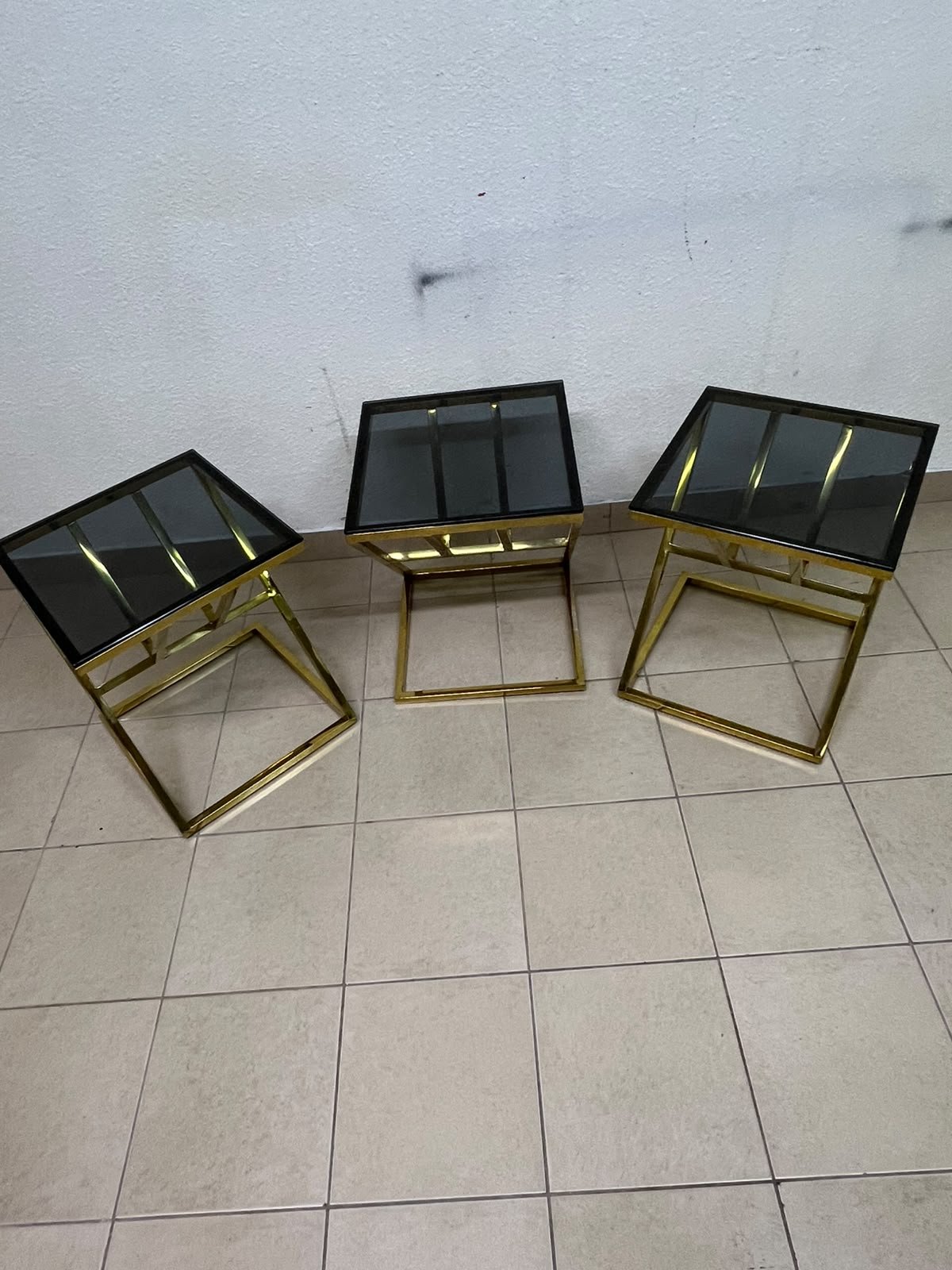 "Zicon" side table set featuring a contemporary geometric Z-shaped design, with gold-finished stainless steel or metal bases and dark or reflective glass tops. - Image 5