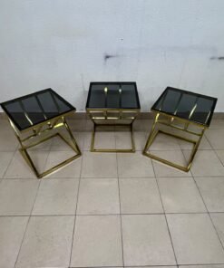 "Zicon" side table set featuring a contemporary geometric Z-shaped design, with gold-finished stainless steel or metal bases and dark or reflective glass tops. - Image 6