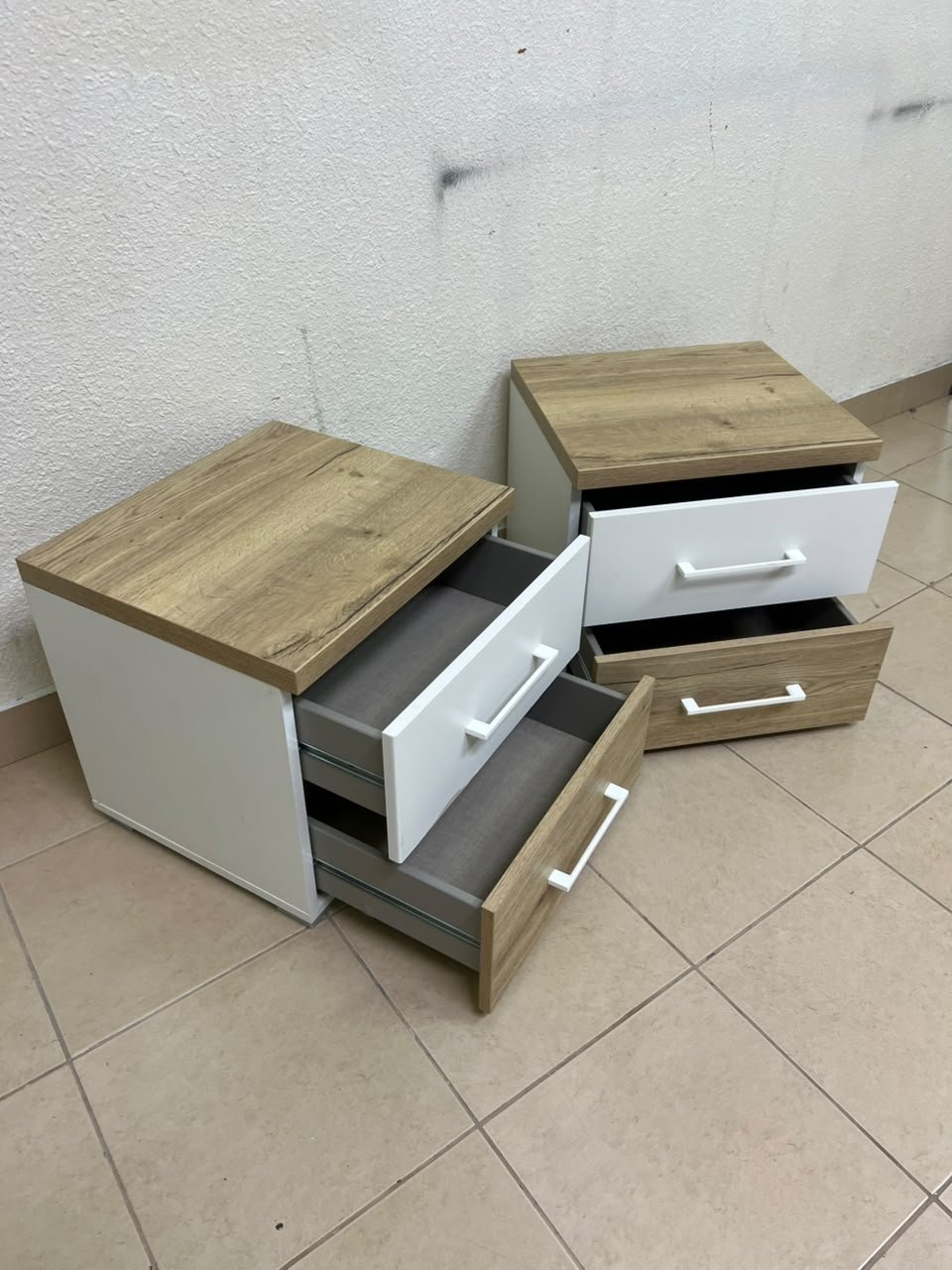 Two bedside tables (nightstands) with two drawers, featuring a design that combines white and light wood (oak or Sonoma finish) with prominent white handles. - Image 4