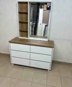 A modern-style dressing table featuring six practical storage drawers and an oak-colored wooden top, complete with a vertical mirror and an attached side shelving unit.
