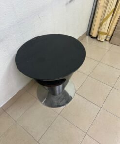 A modern, cone-shaped coffee or side table featuring a circular metal base and a round tabletop. It includes an integrated side opening—suitable for use as a cup holder or small storage unit—and boasts a sleek, streamlined design that is ideal for compact spaces. - Image 11
