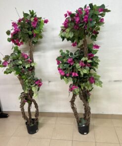 An artificial Bougainvillea tree featuring attractive pink blossoms and green foliage, distinguished by natural, expertly braided wooden trunks and set in black plastic pots.