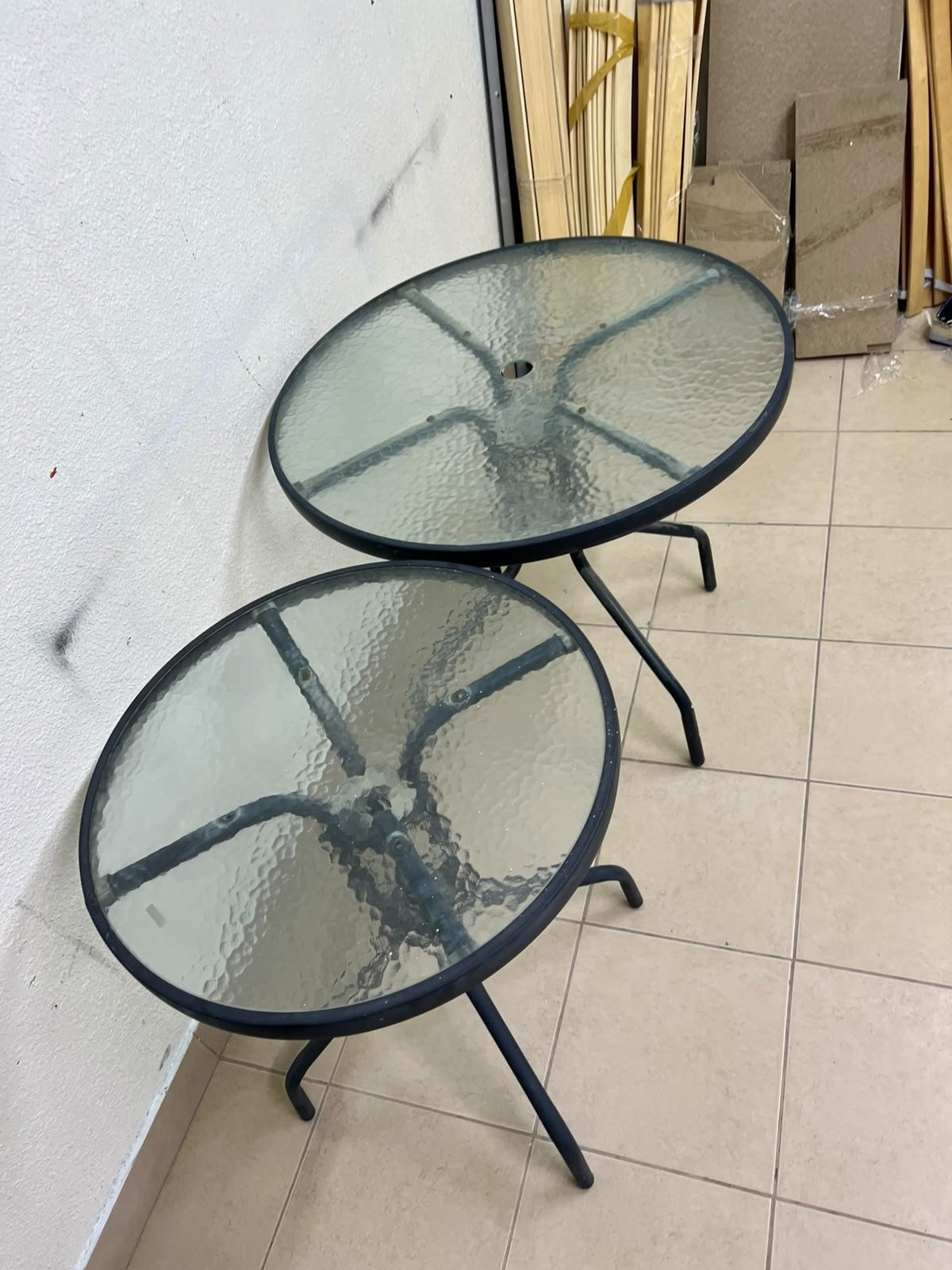 A round garden table featuring a black metal frame and a tempered glass top, suitable for outdoor use on balconies or in gardens. - Image 3
