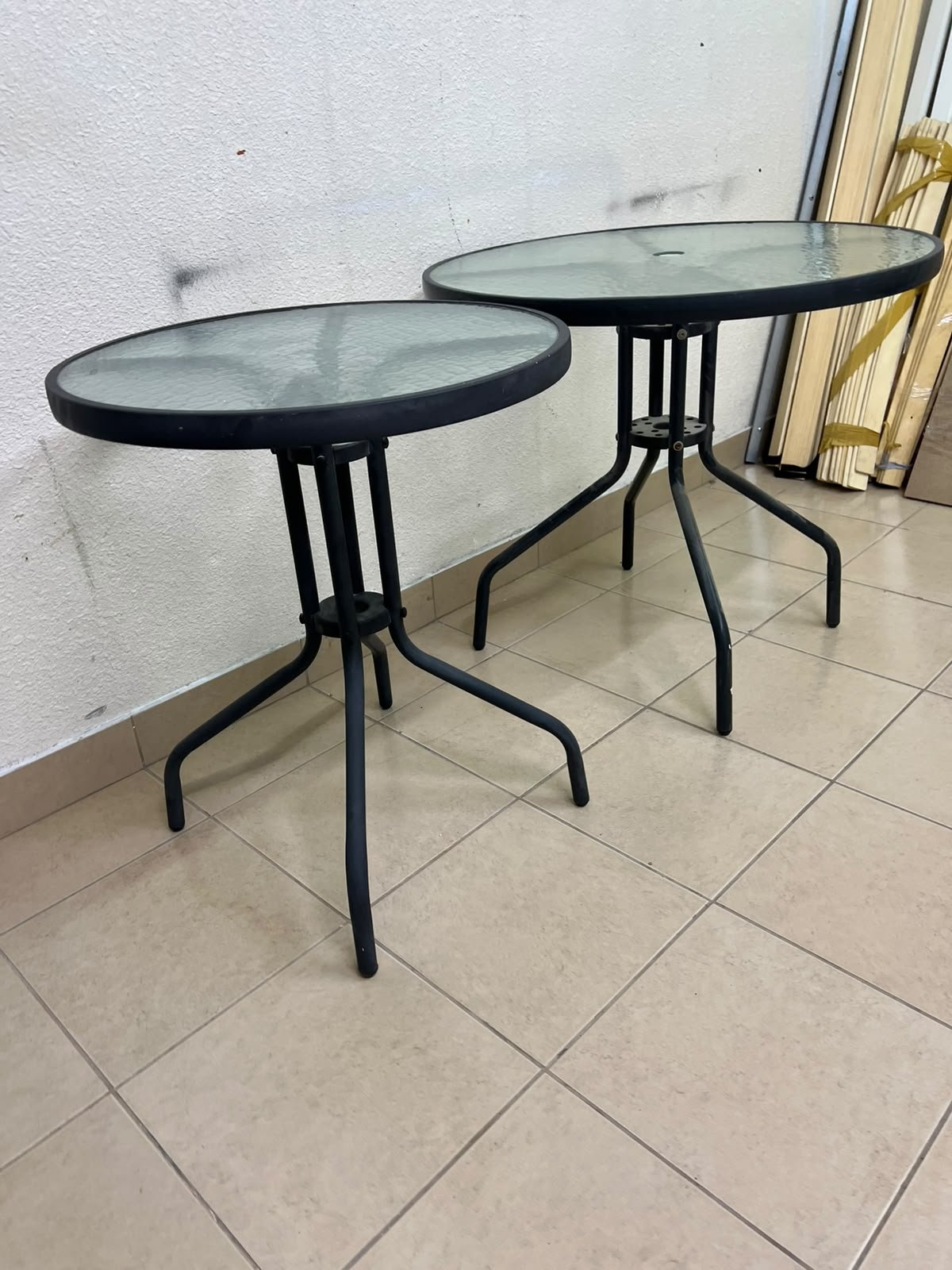 A round garden table featuring a black metal frame and a tempered glass top, suitable for outdoor use on balconies or in gardens. - Image 5