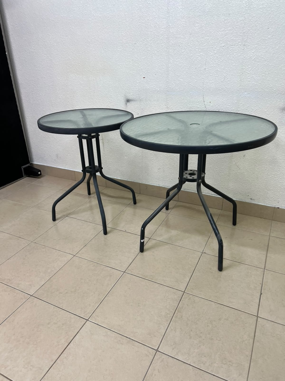 A round garden table featuring a black metal frame and a tempered glass top, suitable for outdoor use on balconies or in gardens. - Image 7