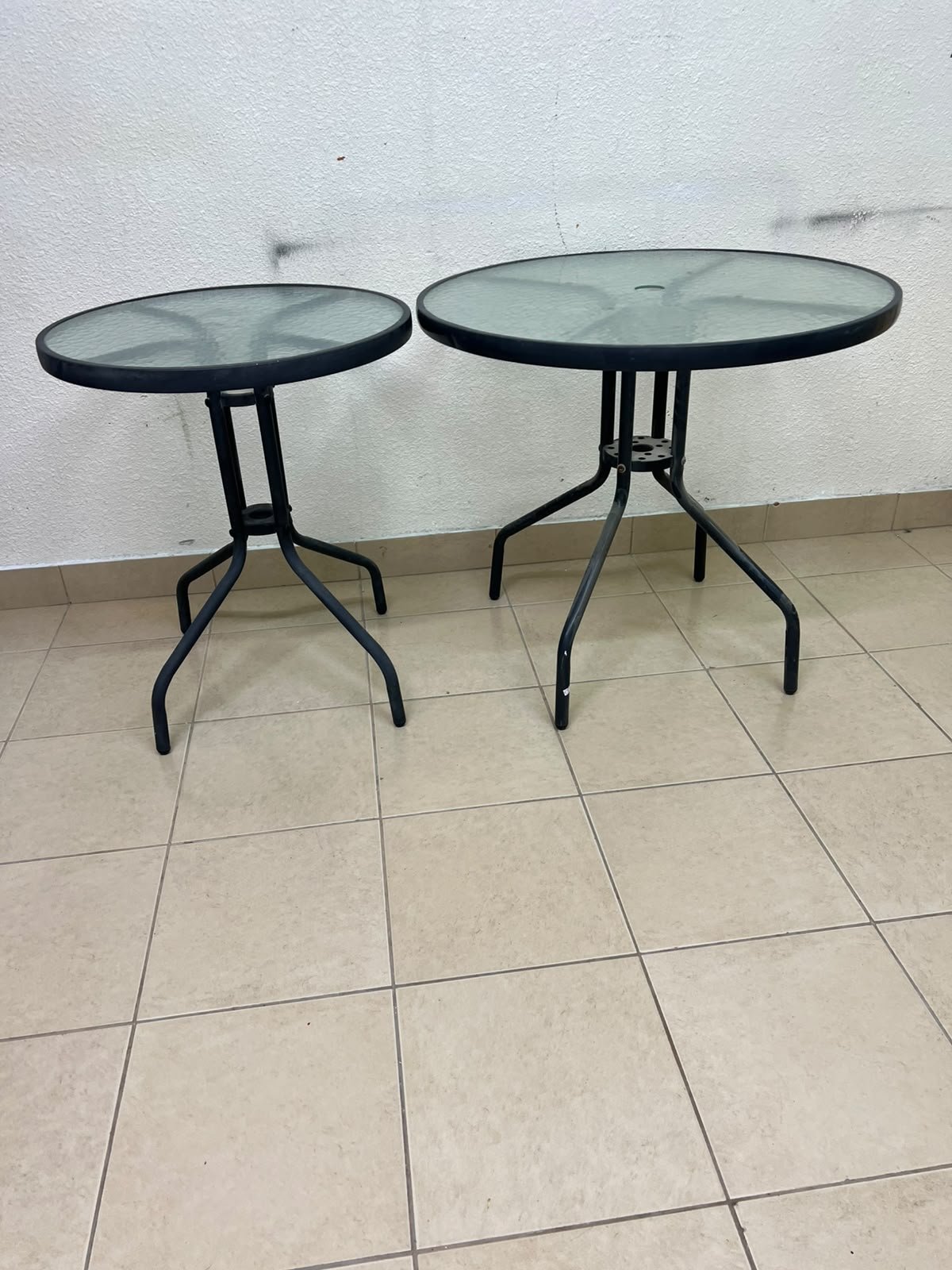 A round garden table featuring a black metal frame and a tempered glass top, suitable for outdoor use on balconies or in gardens. - Image 9