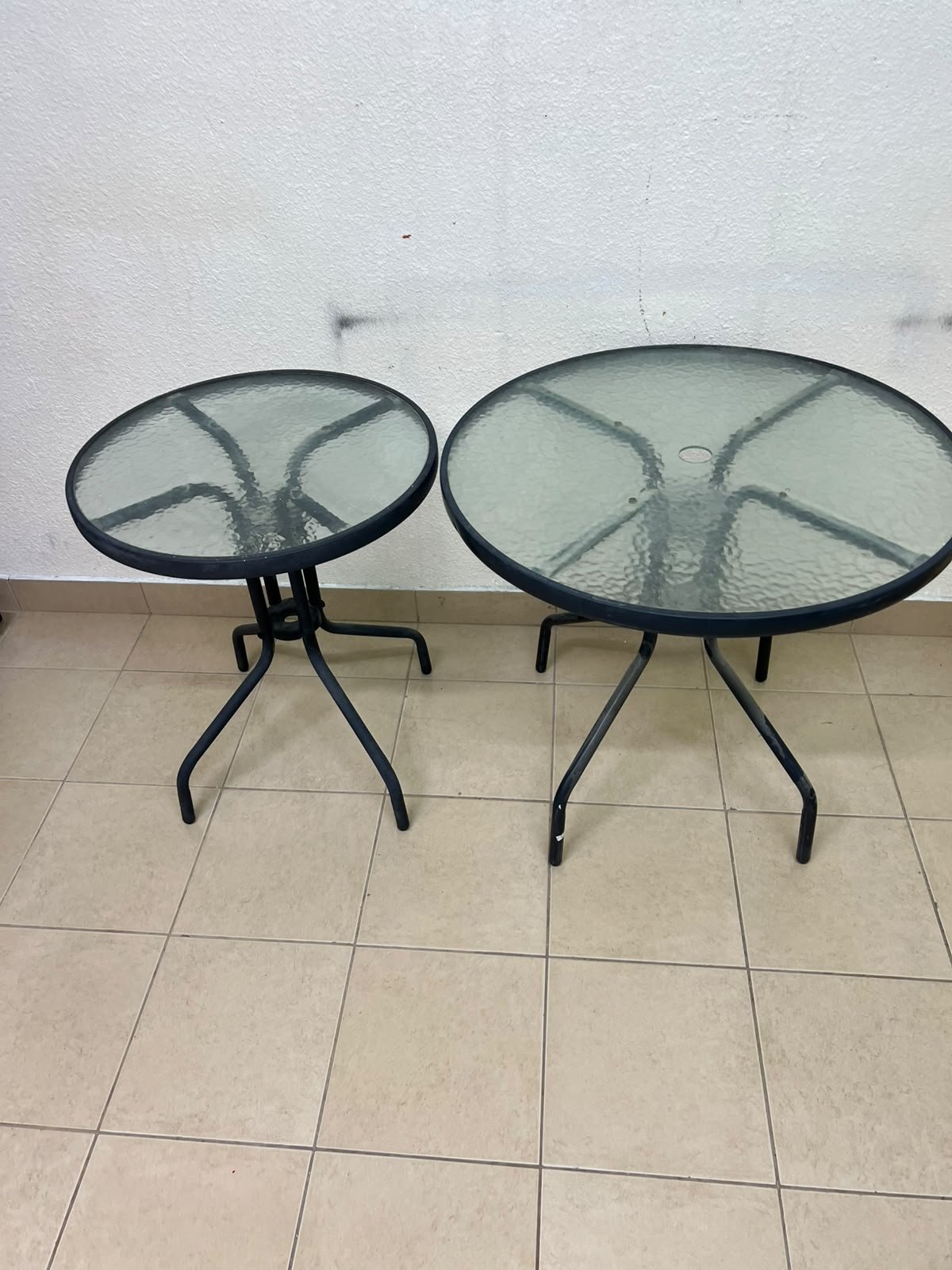 A round garden table featuring a black metal frame and a tempered glass top, suitable for outdoor use on balconies or in gardens. - Image 10