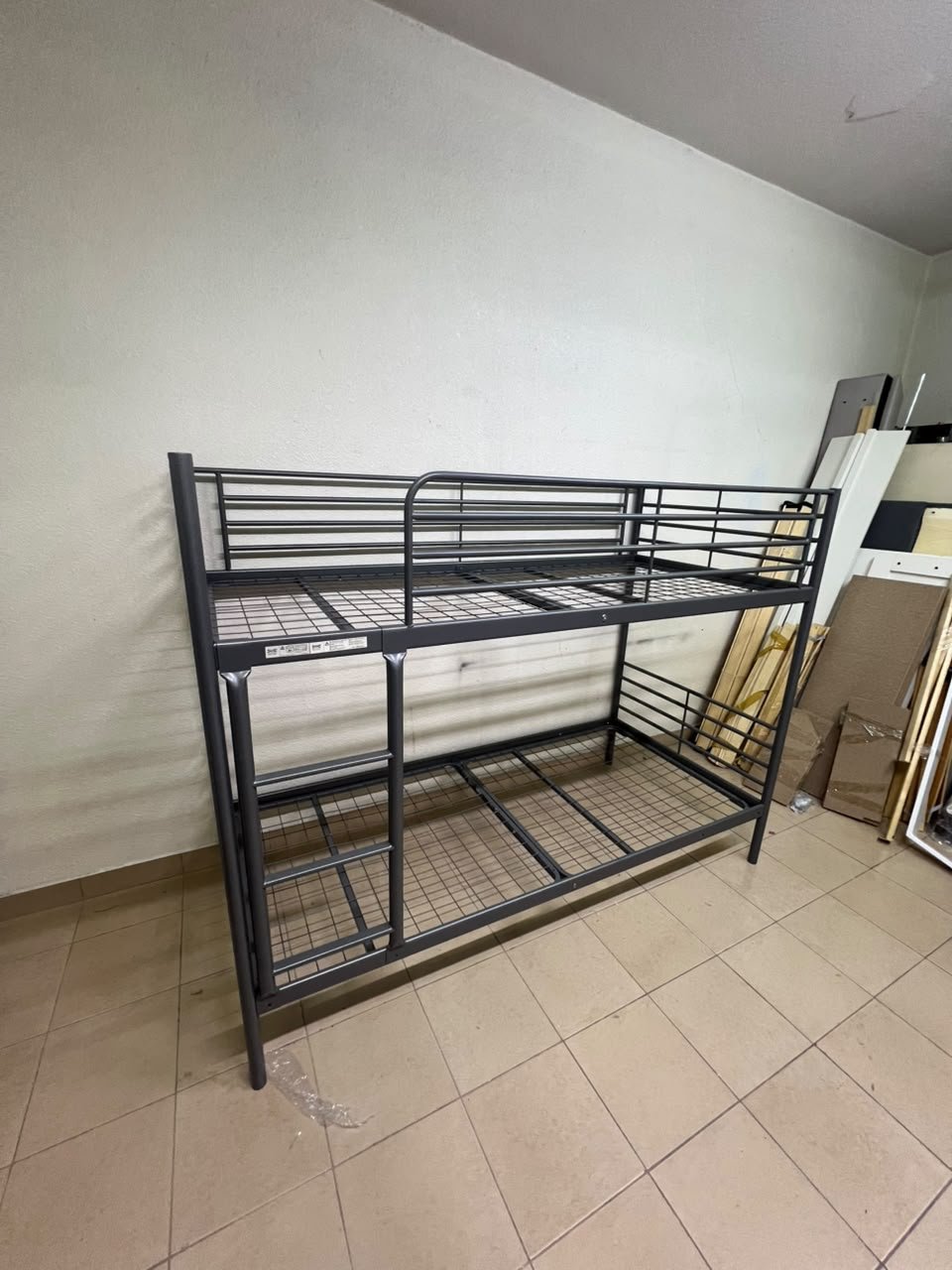 A metal bunk bed (similar to a metal bunk bed of a comparable style on Noon) featuring a solid iron frame with a built-in ladder and a mesh base. - Image 2