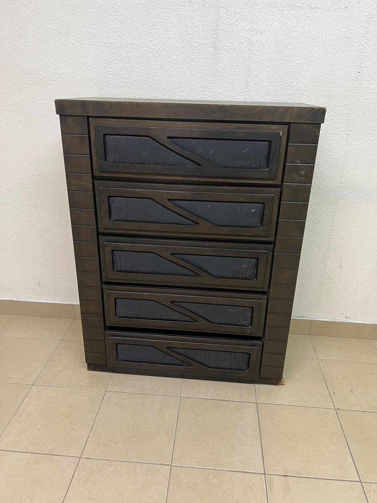 A tall, 5-drawer wooden chest featuring a dark walnut finish and a front design with raised geometric patterns. - Image 11