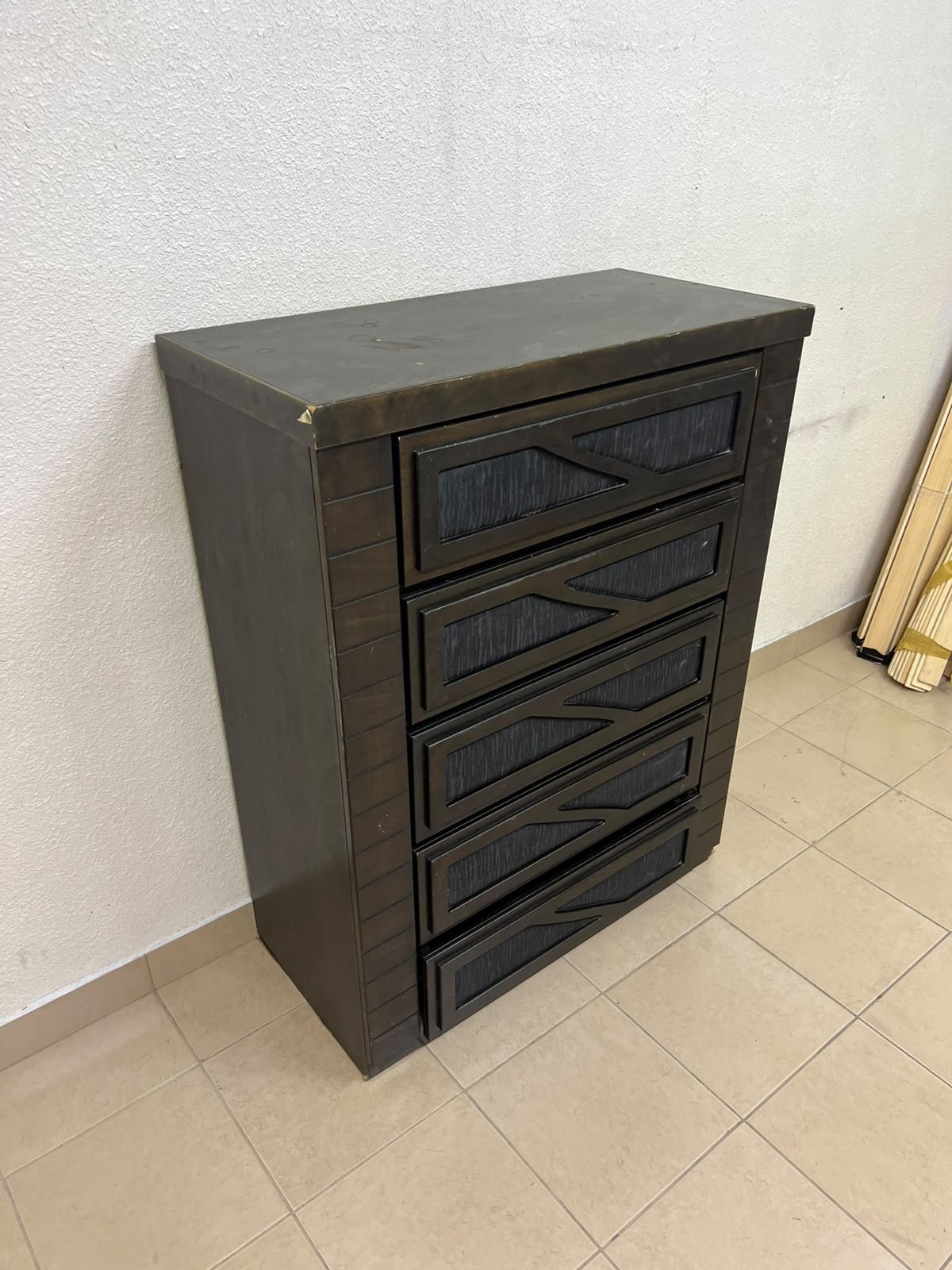 A tall, 5-drawer wooden chest featuring a dark walnut finish and a front design with raised geometric patterns. - Image 3