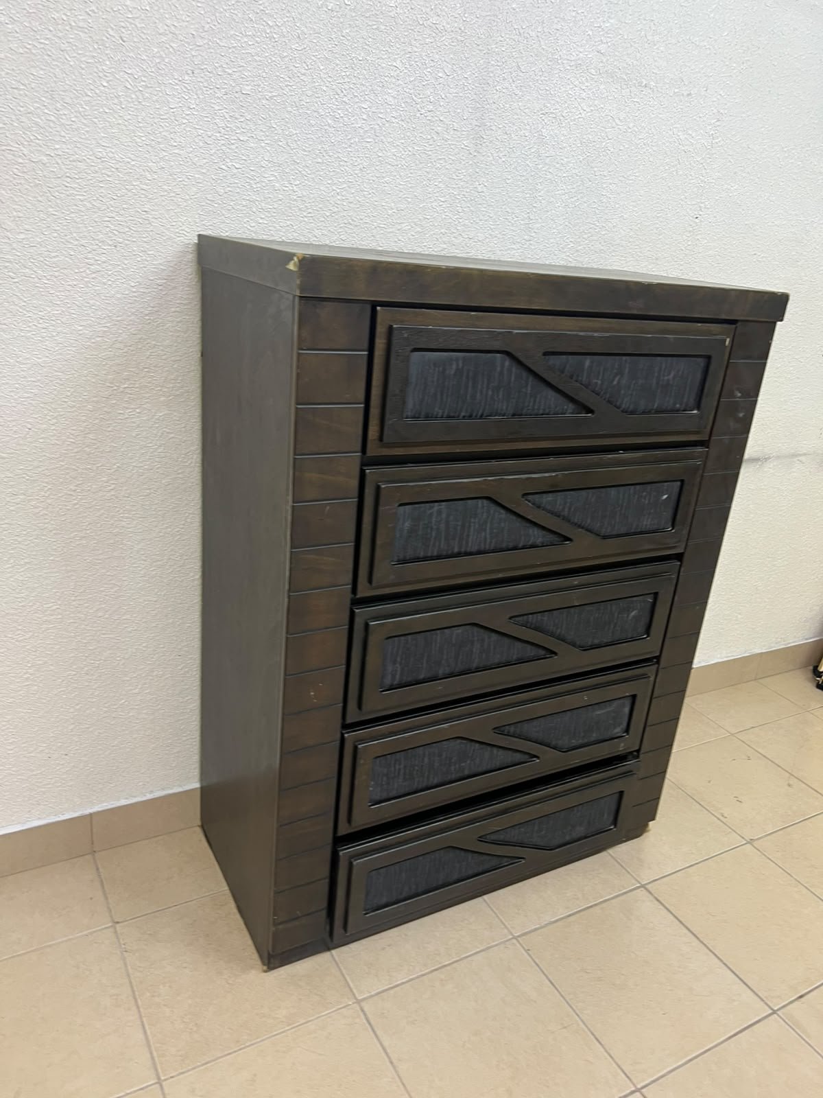A tall, 5-drawer wooden chest featuring a dark walnut finish and a front design with raised geometric patterns. - Image 4