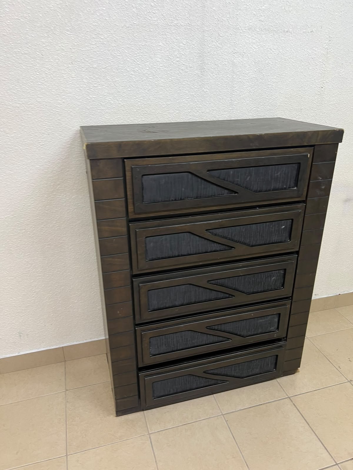 A tall, 5-drawer wooden chest featuring a dark walnut finish and a front design with raised geometric patterns. - Image 7