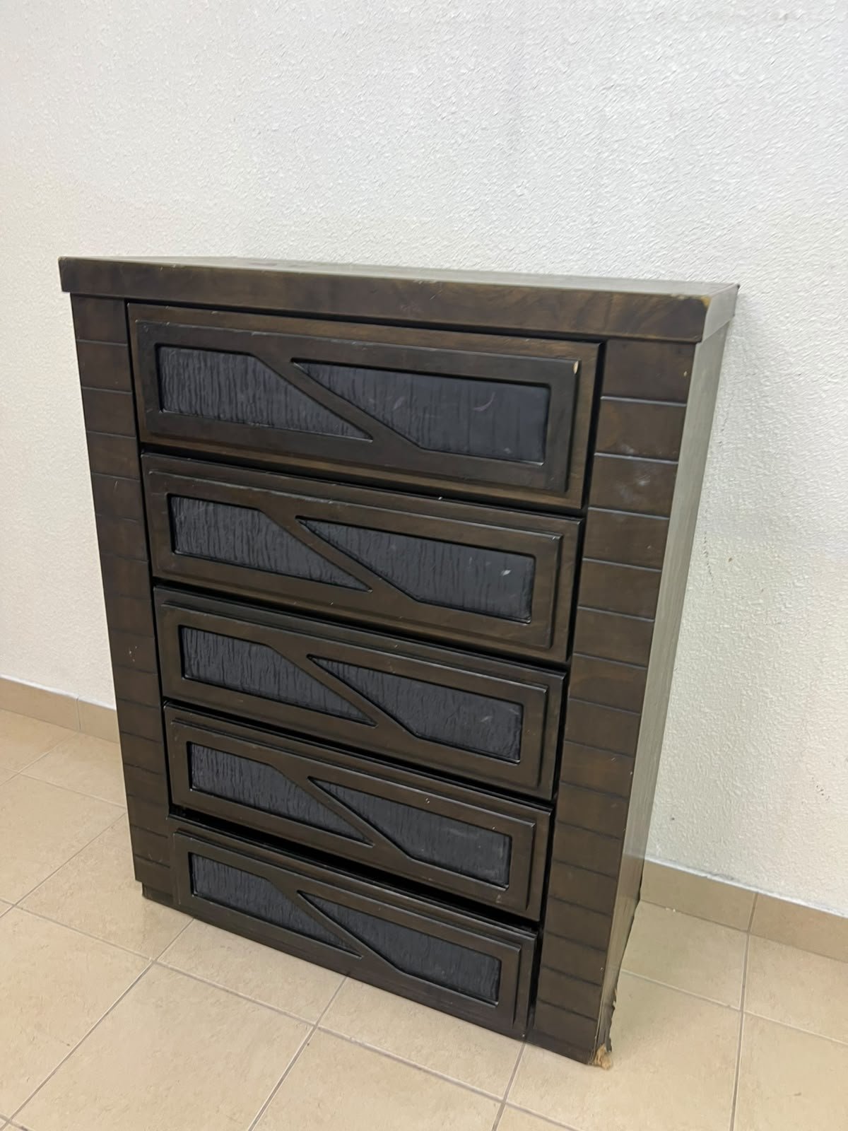 A tall, 5-drawer wooden chest featuring a dark walnut finish and a front design with raised geometric patterns. - Image 9