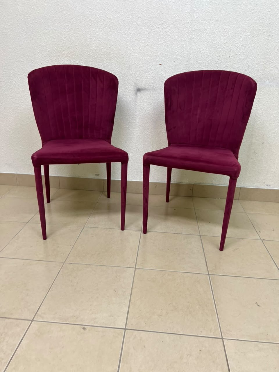 A pair of burgundy velvet dining chairs featuring a vertically ribbed backrest, sturdy metal legs, and an armless design. - Image 12