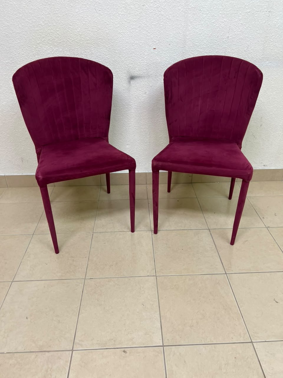 A pair of burgundy velvet dining chairs featuring a vertically ribbed backrest, sturdy metal legs, and an armless design. - Image 2