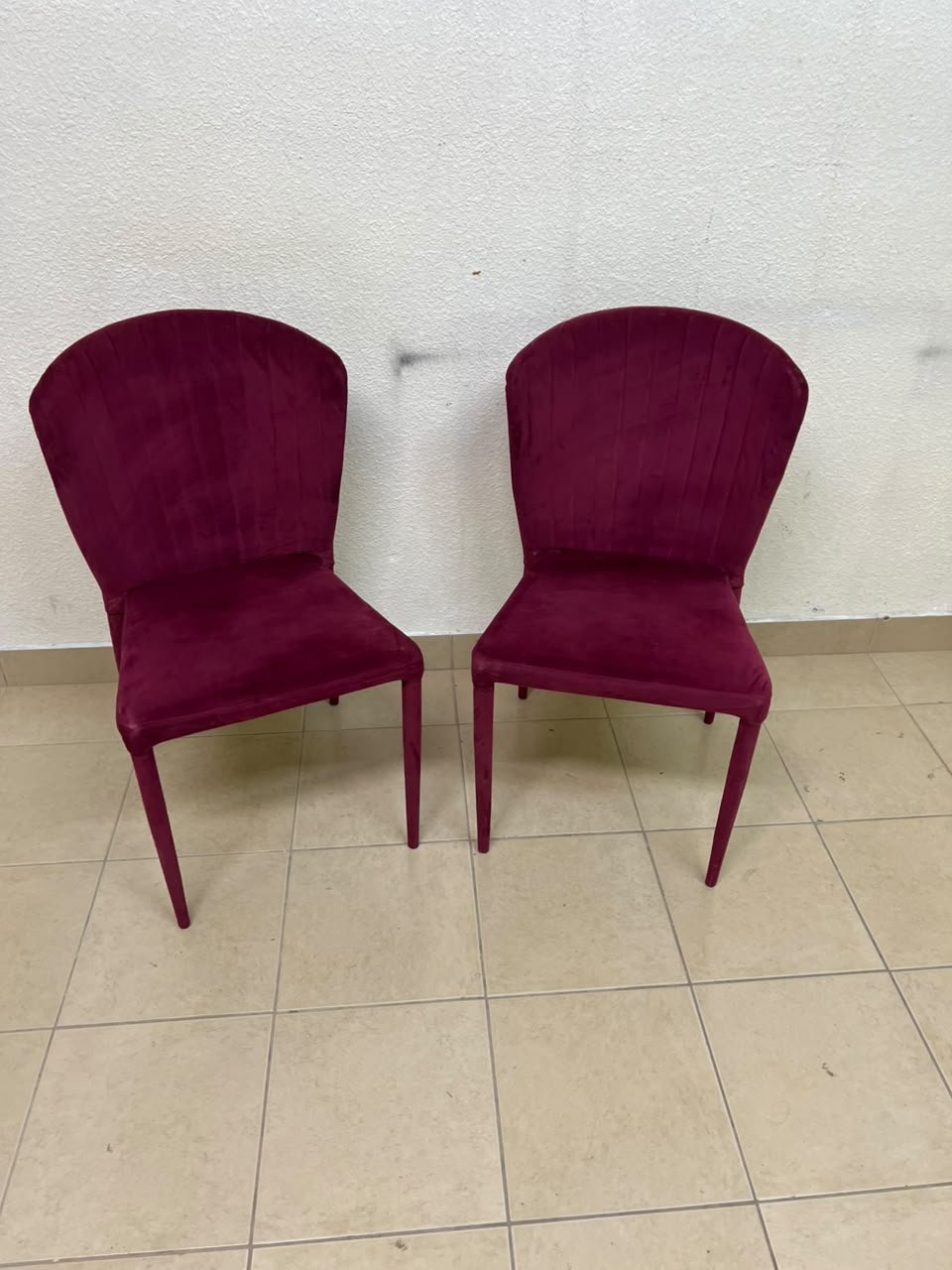 A pair of burgundy velvet dining chairs featuring a vertically ribbed backrest, sturdy metal legs, and an armless design. - Image 7