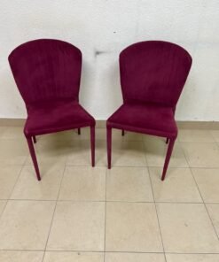 A pair of burgundy velvet dining chairs featuring a vertically ribbed backrest, sturdy metal legs, and an armless design. - Image 8