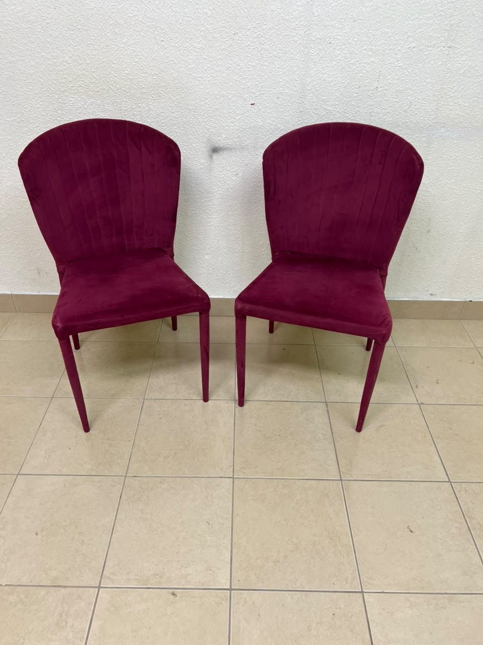 A pair of burgundy velvet dining chairs featuring a vertically ribbed backrest, sturdy metal legs, and an armless design. - Image 8