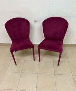 A pair of burgundy velvet dining chairs featuring a vertically ribbed backrest, sturdy metal legs, and an armless design. - Image 9