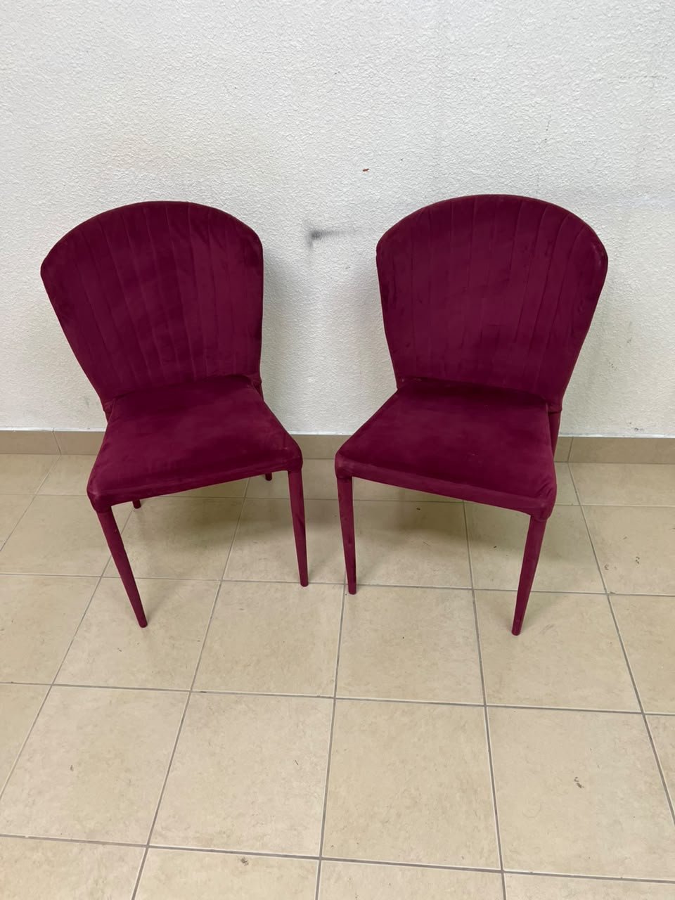 A pair of burgundy velvet dining chairs featuring a vertically ribbed backrest, sturdy metal legs, and an armless design. - Image 9