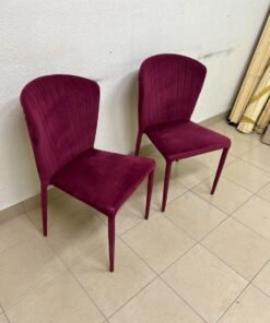 A pair of burgundy velvet dining chairs featuring a vertically ribbed backrest, sturdy metal legs, and an armless design. - Image 10