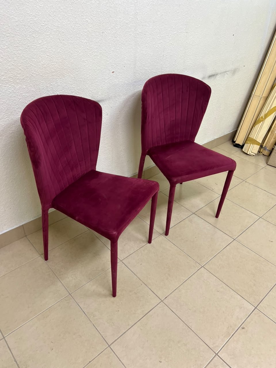 A pair of burgundy velvet dining chairs featuring a vertically ribbed backrest, sturdy metal legs, and an armless design. - Image 10
