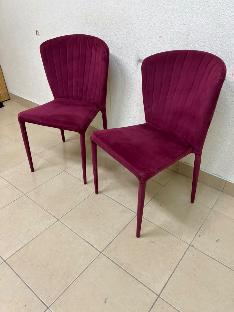 A pair of burgundy velvet dining chairs featuring a vertically ribbed backrest, sturdy metal legs, and an armless design. - Image 5