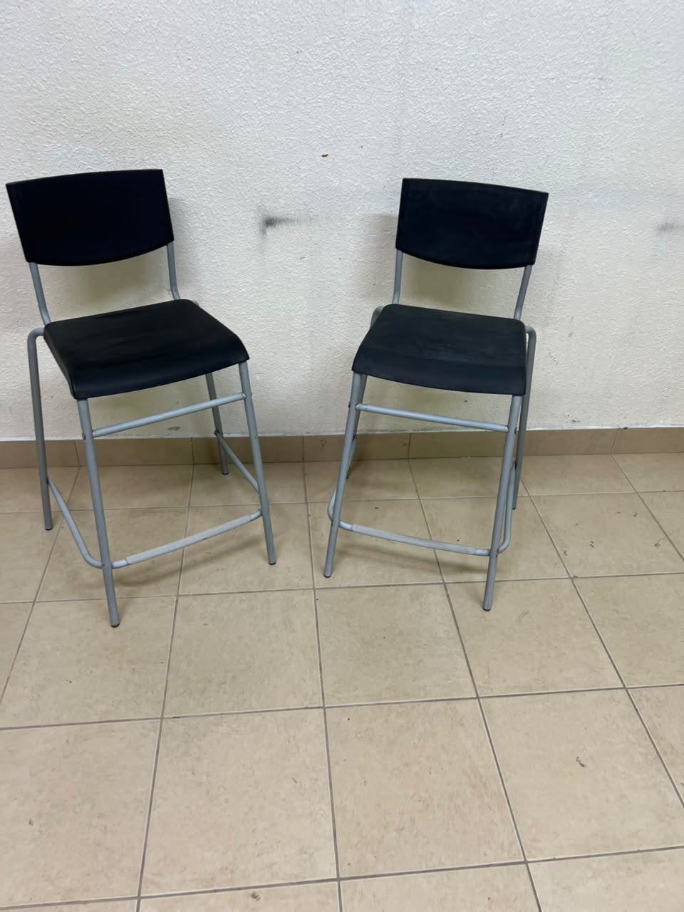 IKEA STIG bar stools, featuring a black seat and backrest with a grey metal frame. - Image 3