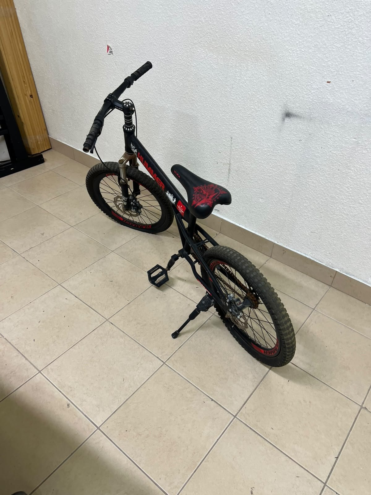 A 20-inch "Hummer"-branded mountain bike featuring a black and red color scheme; it appears to be equipped with a carbon steel or alloy frame, a front suspension system, and dual disc brakes. - Image 5