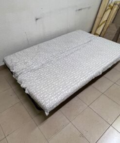 A foldable metal sofa bed (converting into a bed)—the famous IKEA NYHAMN model—featuring a grey-and-white patterned fabric cover and a black frame. - Image 2