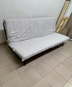 A foldable metal sofa bed (converting into a bed)—the famous IKEA NYHAMN model—featuring a grey-and-white patterned fabric cover and a black frame. - Image 3